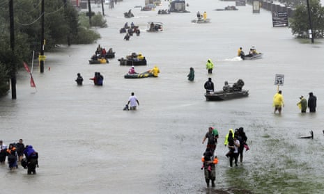 Rescue boats fill a flooded street in Houston after tropical storm Harvey.