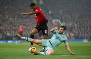 Sokratis takes the ball off Marcus Rashford.