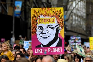 Crowds hold up placards as they march in Melbourne on 20 September as part of the global climate strike.