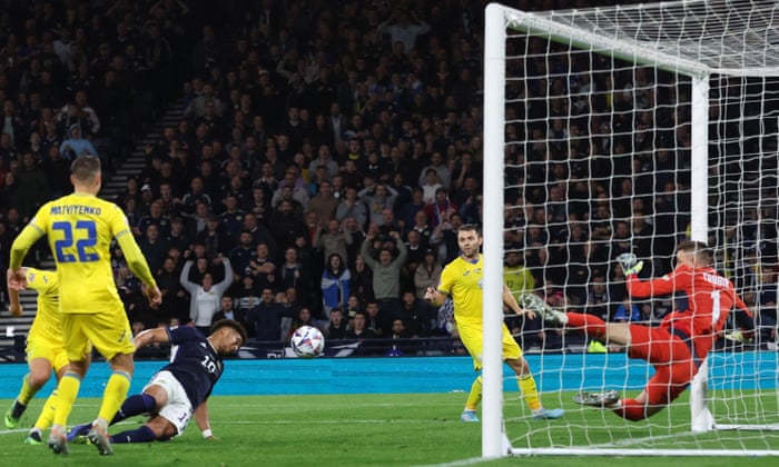 Scotland's Che Adams reacts after his header bounces off the post.