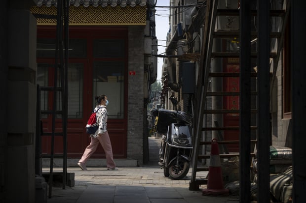 A woman walks in an alley in China’s capital of Beijing