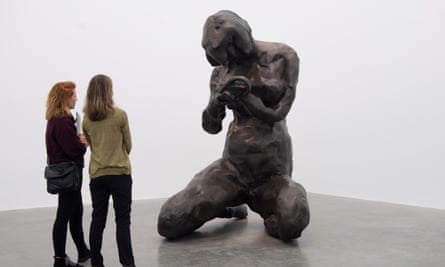 Visitors look at a sculpture by British artist, Tracey Emin, entitled The Mother.
