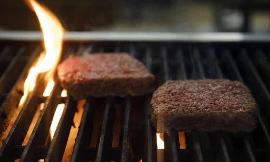 Plant-based burger patties on a grill