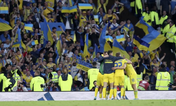 Ukrainian players celebrate in front of the away fans after Artem Dovbyk’s late strike secured victory.