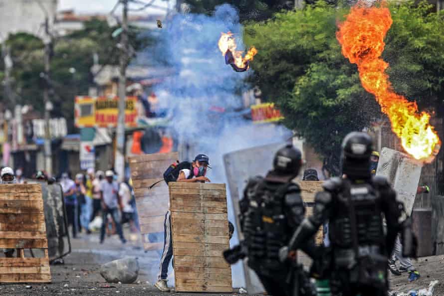 Demonstrators and riot police clash in Cali, Colombia, on 29 April.