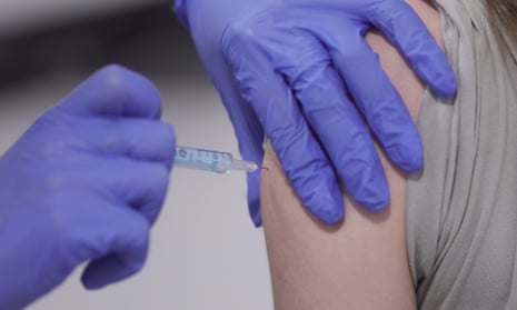 A person receiving a vaccination in their arm