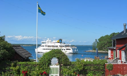 View of ferry on sea with Swedish flag on foreground