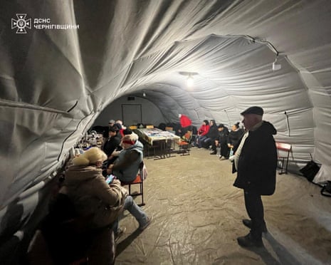 People charge their devices, use internet connection and warm up inside an invincibility centre after critical infrastructure was hit during Russian drone attack in Chernihiv region, Ukraine 21 October 2025.