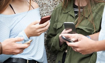 Group of teenagers using mobile phones