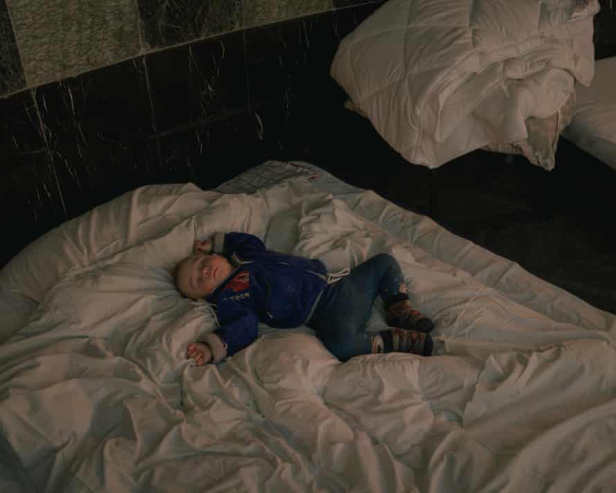 A child sleeps in an improvised emergency shelter in a theatre in Lviv, 7 March