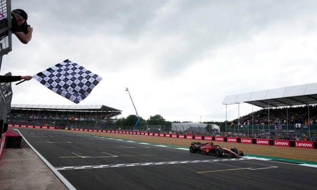Ferrari's Carlos Sainz Jr. crosses the line to win the race 
