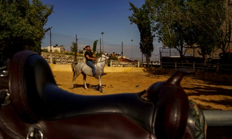 Horse trainer Abu Al Saeed takes the first ride on Abdel Naser Musleh’s stallion in Kufr Aqab