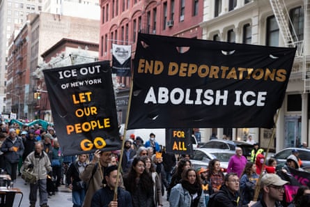 people hold signs against deportations
