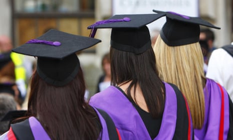 A row of university graduates in robes from behind