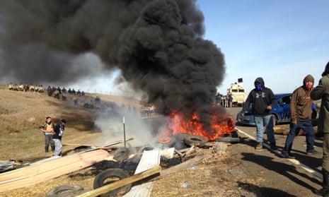 Dakota Access oil pipeline protesters burn debris as officers close in