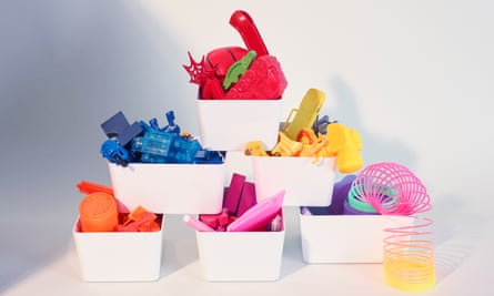 Stacked white boxes containing colour-sorted toys