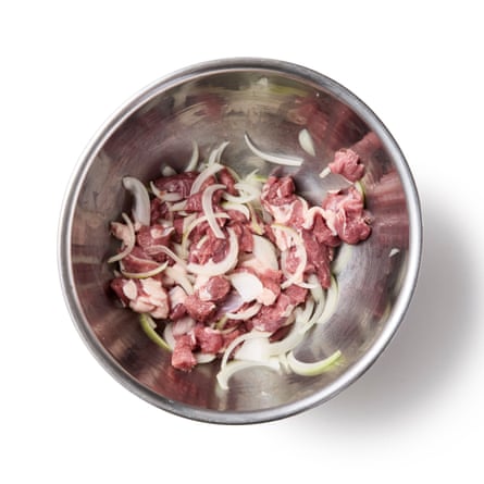 Diced lamb and onions in a silver bowl