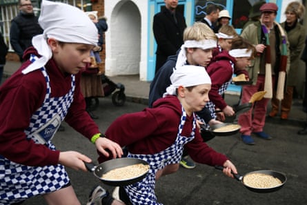 Schoolchildren take part in a pancake race on 9 February in Olney, Buckinghamshire