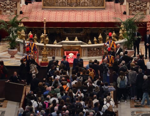 People line up in front of the coffin of the late Pope Francis in St Peter’s Basilica on Friday