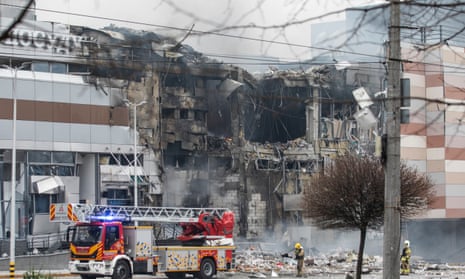 Emergency services work at the site of an overnight rocket attack on a shopping mall in Dnipro.