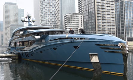 A member of the crew cleans the bow of the PHI superyacht.