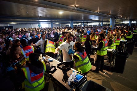 Less rowdy than shoppers … clubbers pass through security gates in what used to be the car park.