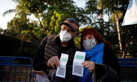 Vaccinated seniors pose with their green passes at a concert in Yarkon park, in Tel Aviv.