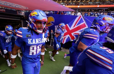 Kansas players run out with a Union Jack flag for kickoff.