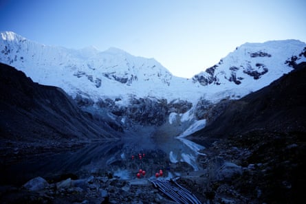 A lake with glaciers in background