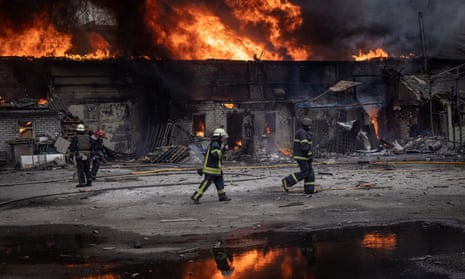 Firefighters work to extinguish a fire at a warehouse after it was hit by Russian shelling on Monday in Kharkiv, Ukraine.