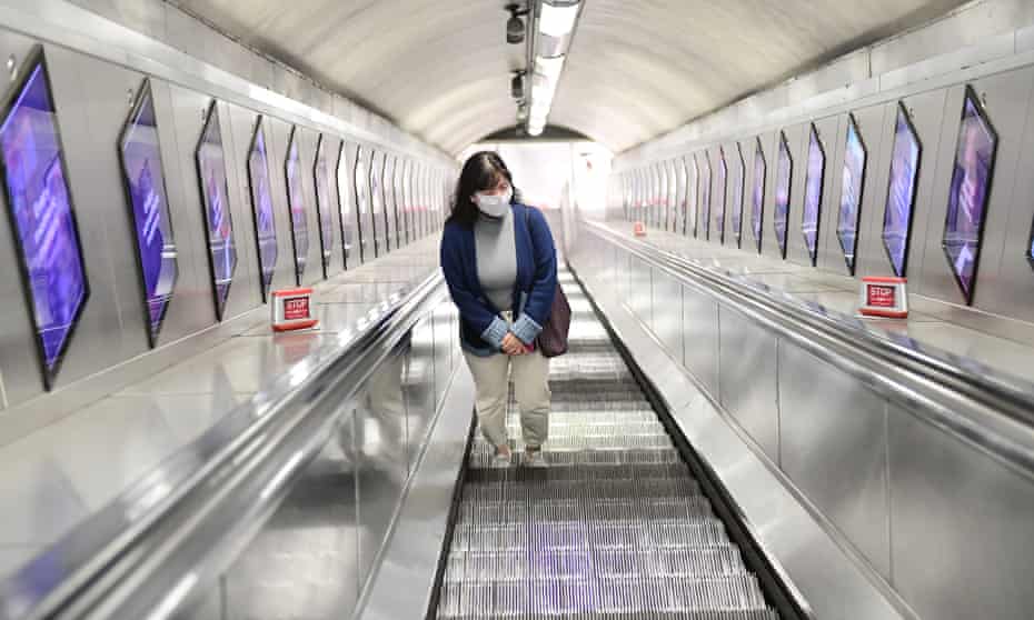 A woman wearing a mask on the London Underground during the coronavirus outbreak. Experts say social distancing will impact the rate of fatalities. 
