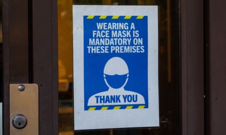 Covid-19 face mask sign in shop window