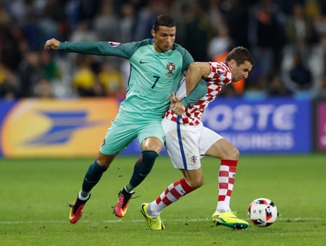 Portugal’s Cristiano Ronaldo tussles with Croatia’s Darijo Srna.
