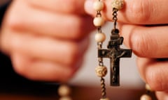 Hands holding rosary beads