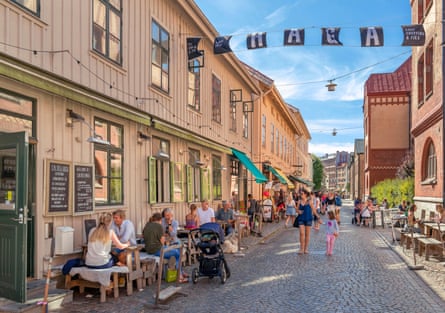 A street in Gothenburg with people sitting outside cafes