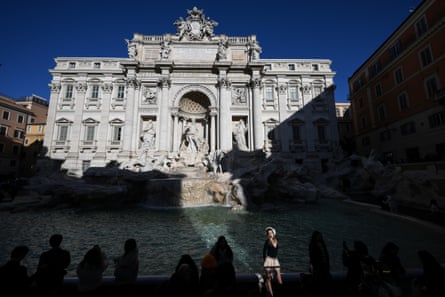 A woman poses for a photo next to the fountain