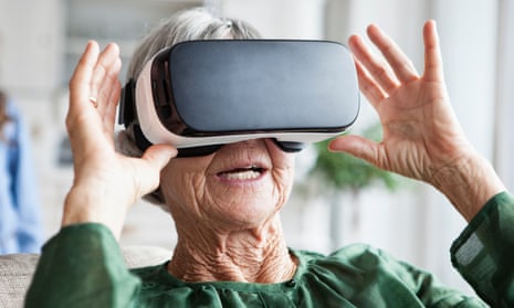 An older woman using VR glasses