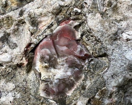 A close-up of the Nine Stones stone circle, showing chunks of pink flint, an unusual colour caused by iron elements present when the stone formed.