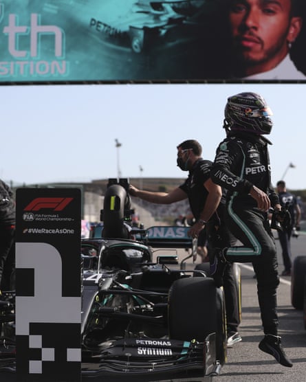 Lewis Hamilton climbs out of his Mercedes after parking it up by the pole-sitter’s board