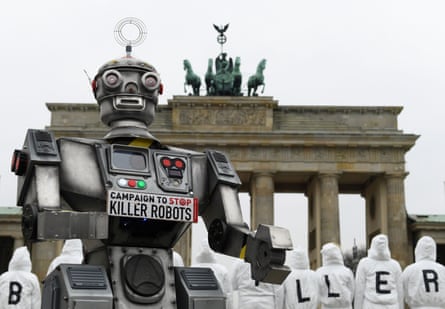 A mock-up of a killer robot in front of the Brandenburg Gate in Berlin.