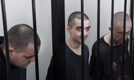 British citizens Aiden Aslin (left) and Shaun Pinner (right), with Moroccan Brahim Saadoun in a courtroom in Donetsk in June. All three were released this week.