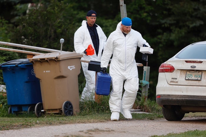 A police forensics team investigates a crime scene after multiple people were killed and injured in a stabbing spree in Weldon, Saskatchewan.