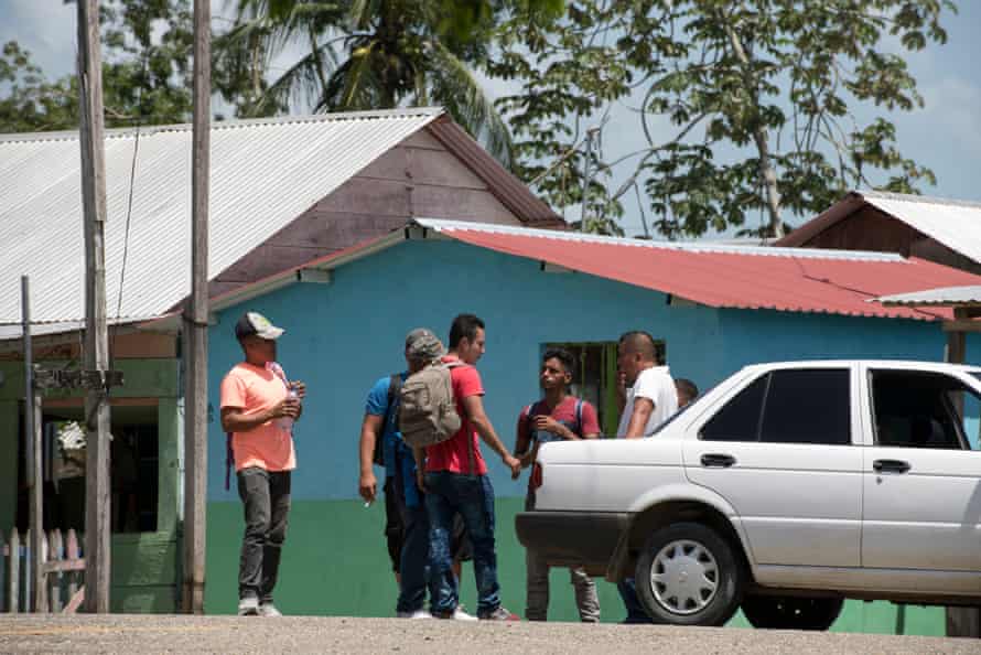 Migrants from Central America attempt to agree a price with a local smuggler for the journey from Frontera Corozal to Palenque, Chiapas.