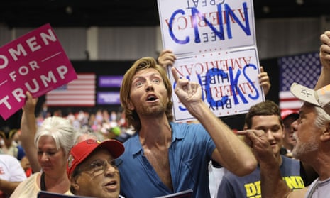 A ‘CNN sucks’ sign at a Trump rally in Tampa on Tuesday night. Trump has intensified his criticism of the media and embraced the hostile attitude among his supporters towards members of the press.