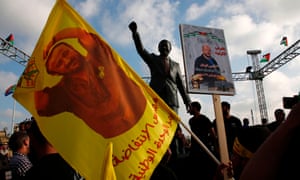 Protesters wave flags and portraits of Palestinian leader and prisoner Marwan Barghouti in the West Bank city of Ramallah.