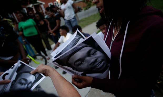 Demonstrators distribute photos of Paul O’Neal before protesting his fatal shooting by a Chicago police officer.