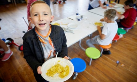 Eight-year-old Michael Medenica eating a Can Cook Kitchen curry at Quayplay summer scheme in Flintshire, north Wales.