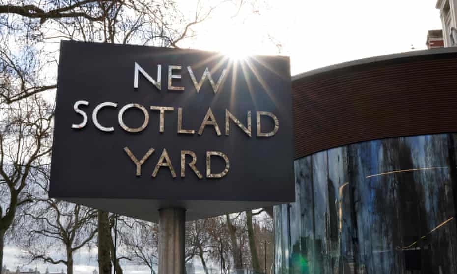 The New Scotland Yard sign is seen in London