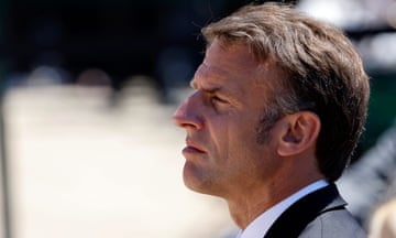 Profile photo of the French president, Emmanuel Macron, dressed in a black and white suit looking into the distance.