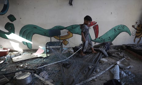 A Palestinian child navigates through heavy damage to a UNRWA school sheltering displaced persons the day after a nearby house was targeted by Israeli bombardment in Khan Younis, southern Gaza Strip, Friday, June 21, 2024. (AP Photo /Jehad Alshrafi)